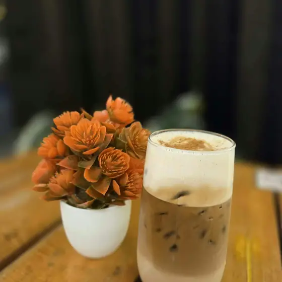 An iced latte with cinnamon foam
