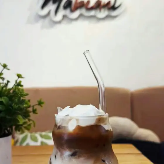 An iced latte with a cream top