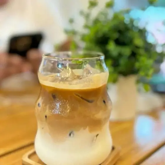 An iced latte in a wavy glass