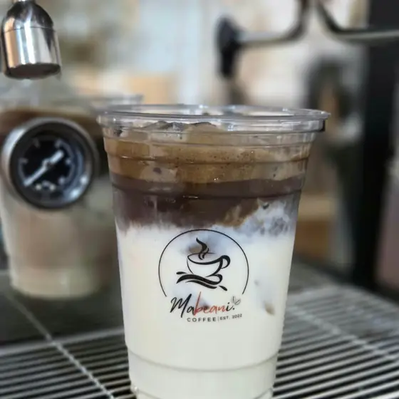 An iced latte at the espresso machine
