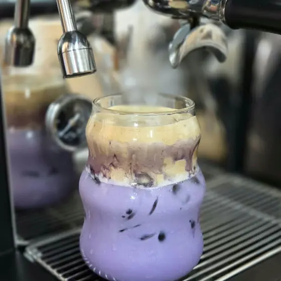A purple ube drink at the espresso machine