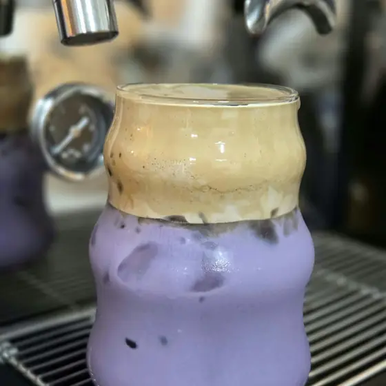 Purple Wave ube drink with a foamy top