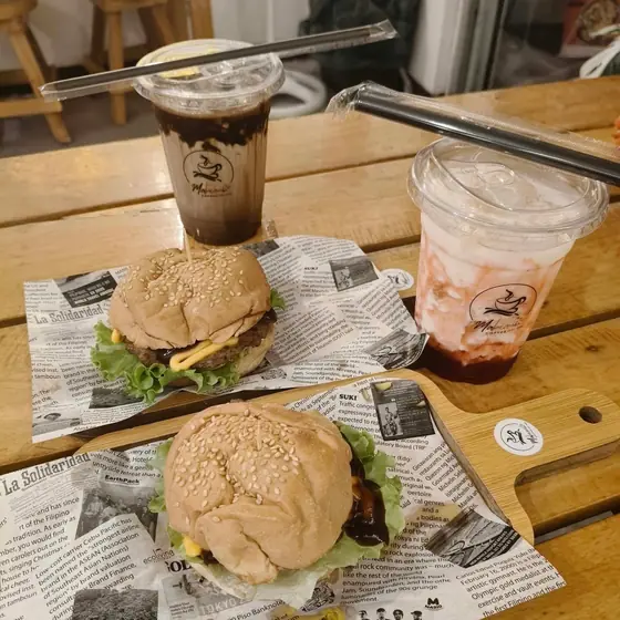 Two burgers served with cold drinks