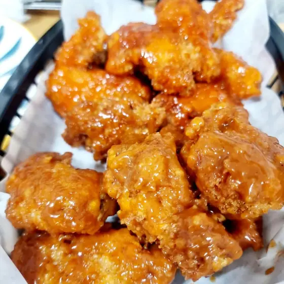 Honey glazed chicken wings in a basket