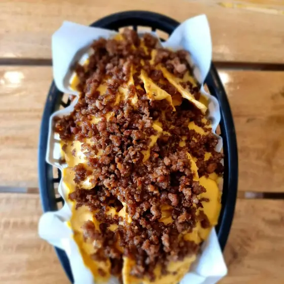 Nachos loaded with ground meat and cheese sauce