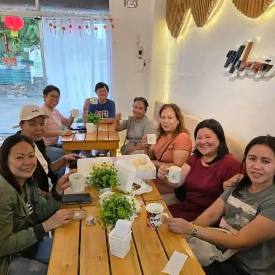 Friends celebrating with coffee and cake