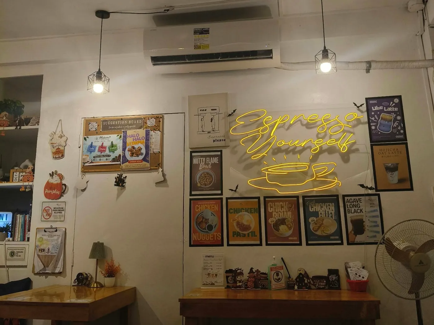 The yellow Espresso Yourself neon sign on the wall inside Mabeani Coffee